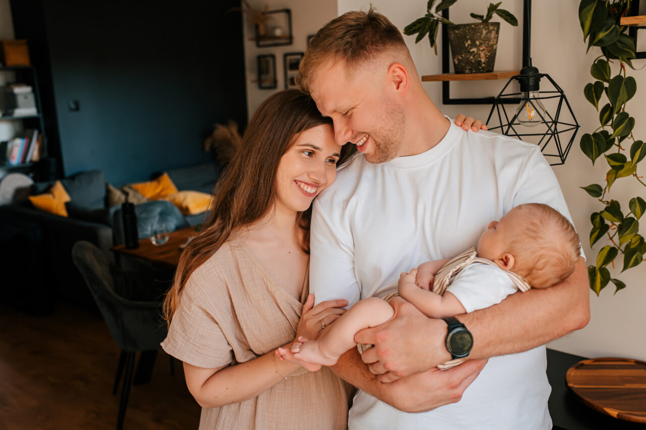 Rodzice tulą noworodka podczas domowej sesji – fotograf rodzinny Łódź